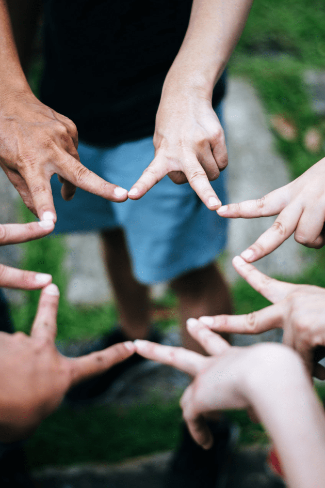 Women and men friends make star shape from fingers. Success, friendship concept.